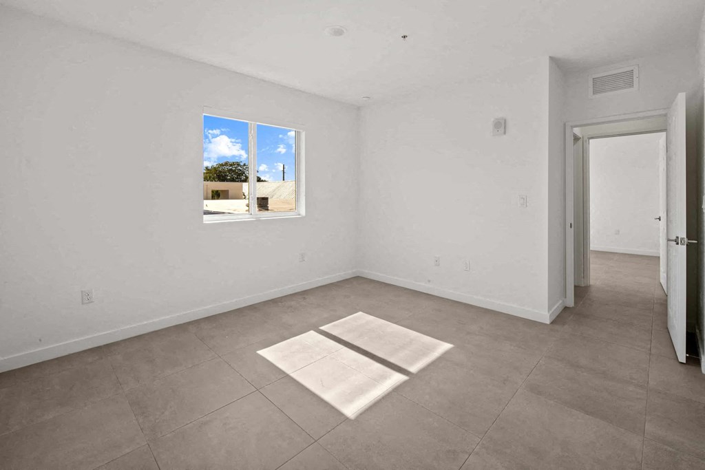 a living room with a door and a window on the wall