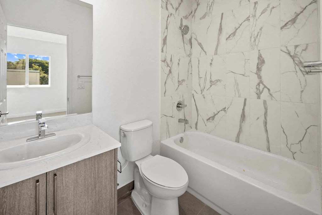 a bathroom with a sink toilet and a bath tub