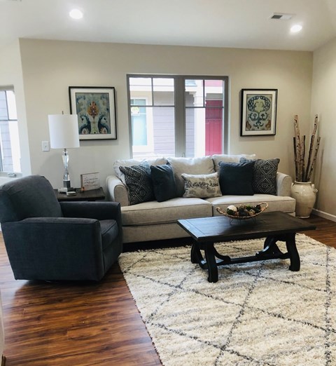 A living room with a couch, chair, and coffee table.