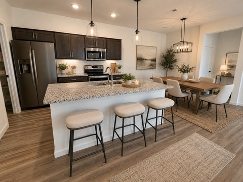 A kitchen with a bar area and a dining table.