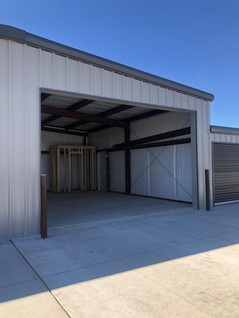 A large white building with a closed garage door.