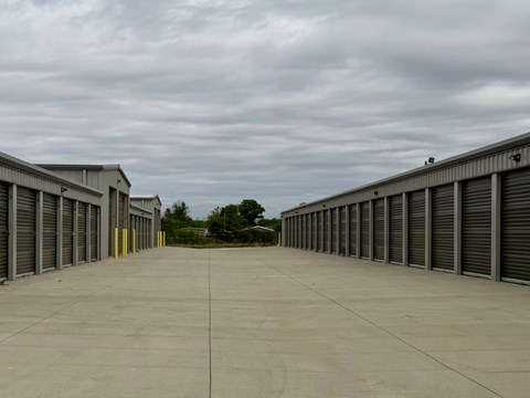 A long row of storage units with closed grey doors.