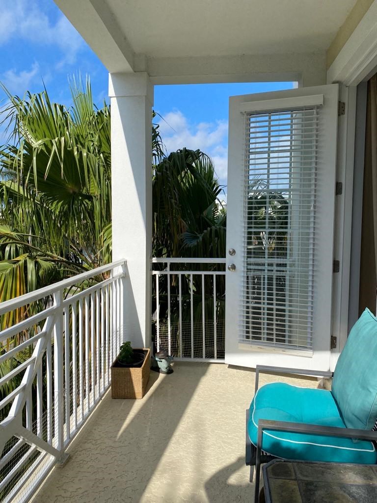 a view of a balcony with a chair and a door
