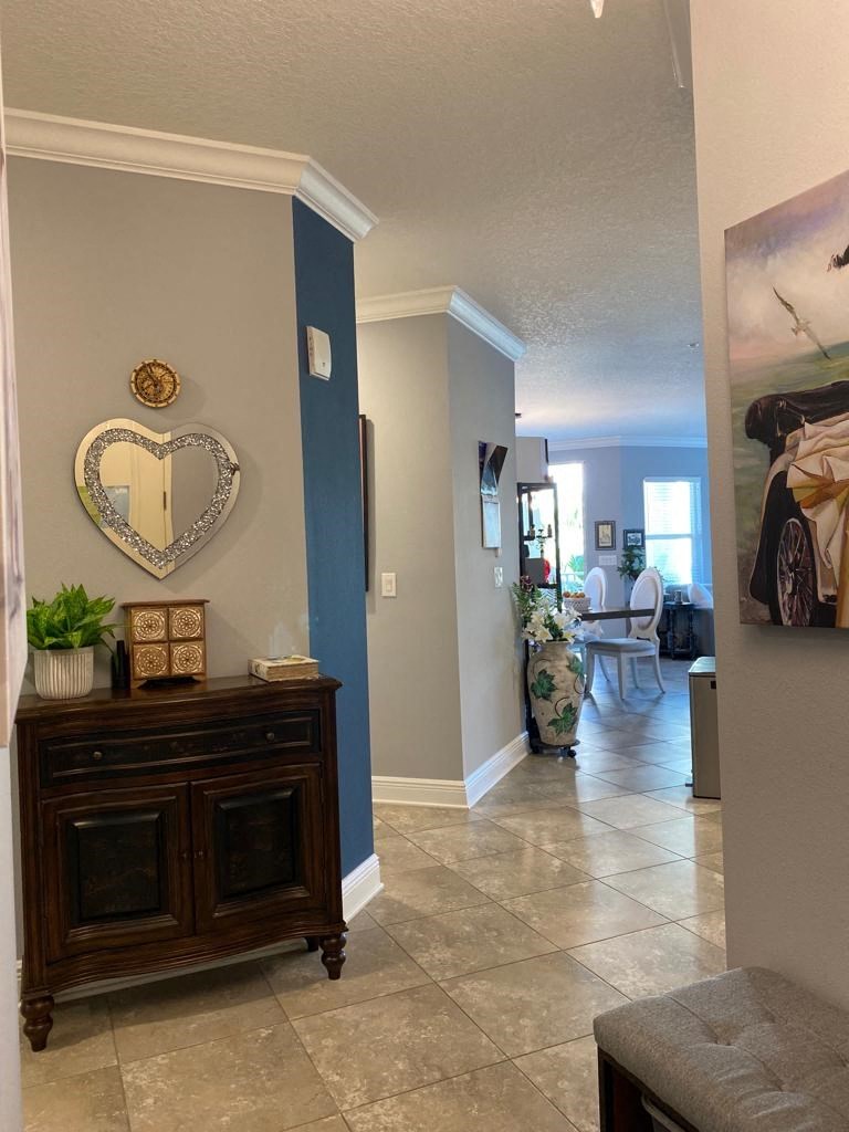 a living room with a dresser and a heart shaped mirror