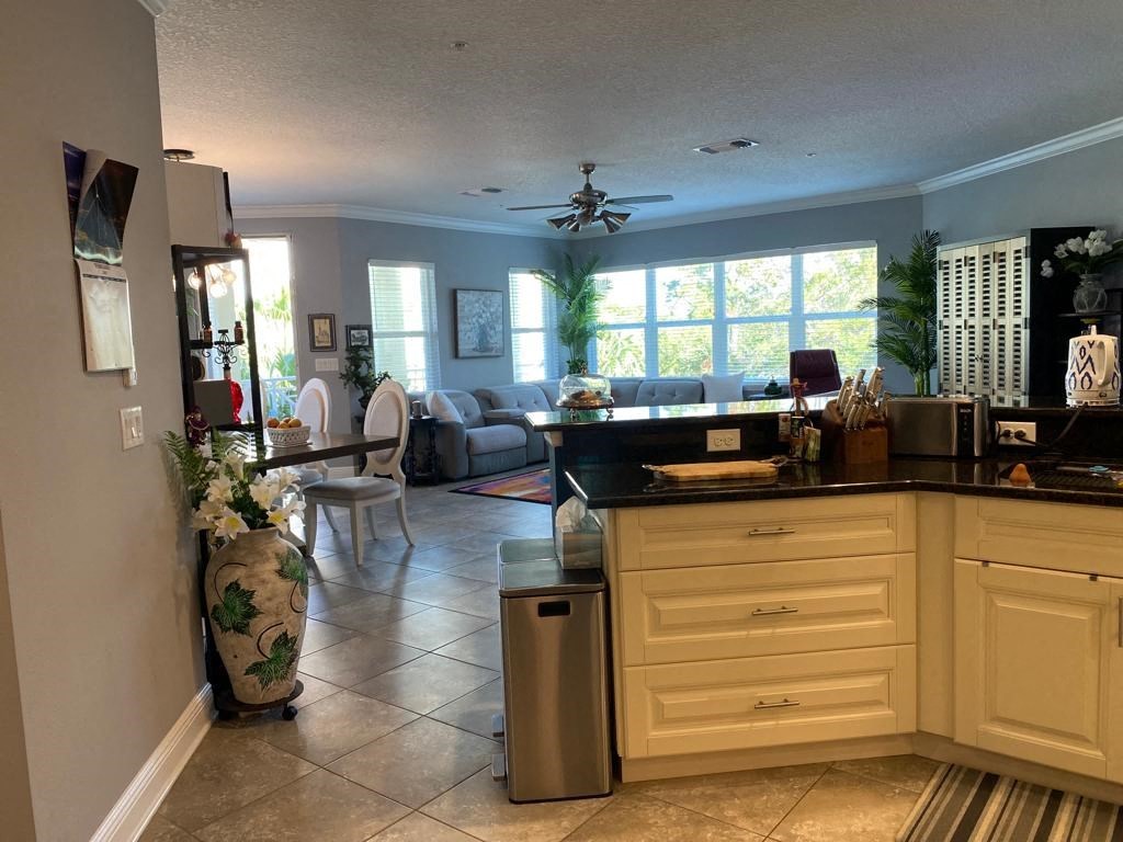 a kitchen with a counter top and a living room