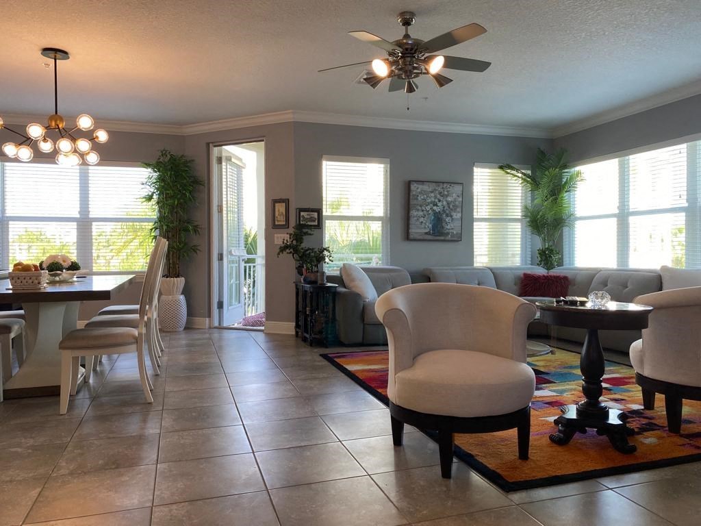 a living room and dining room with a ceiling fan