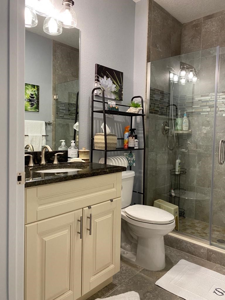 a bathroom with a toilet and a shower