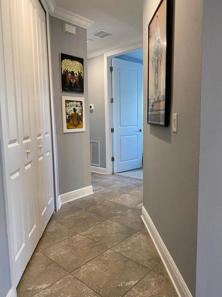 a hallway with tile flooring and a blue door