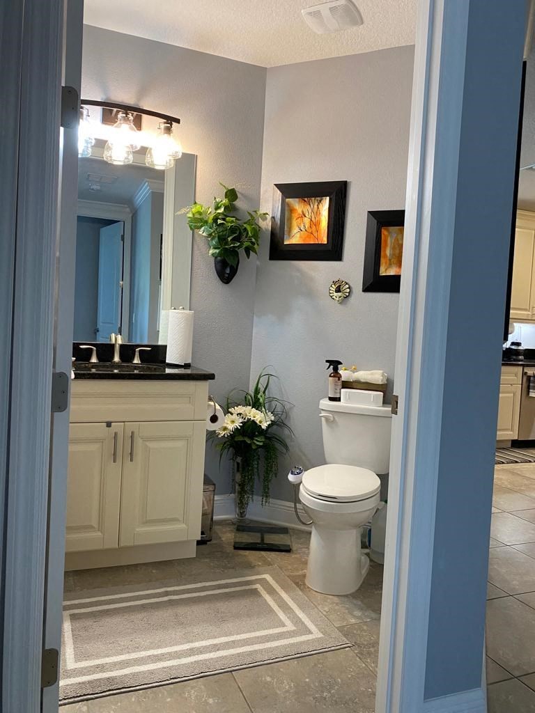 a bathroom with a toilet and a sink and a mirror