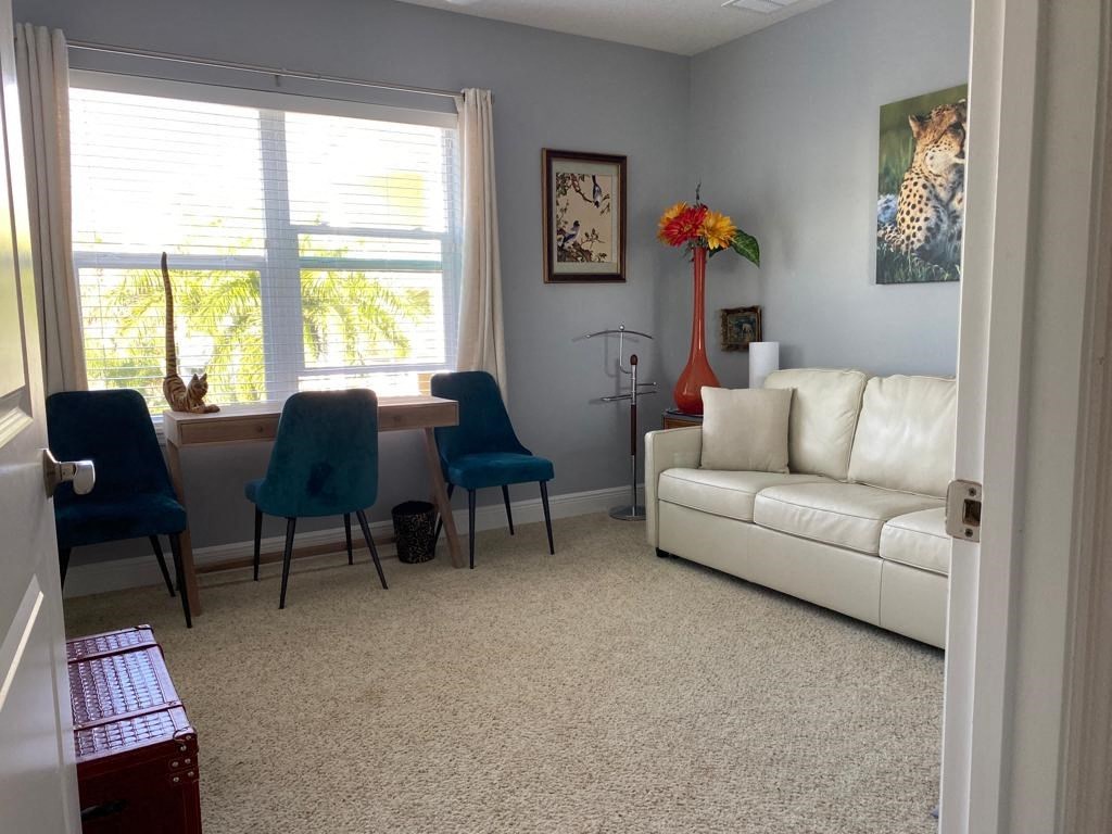 a living room with a couch and a table with chairs