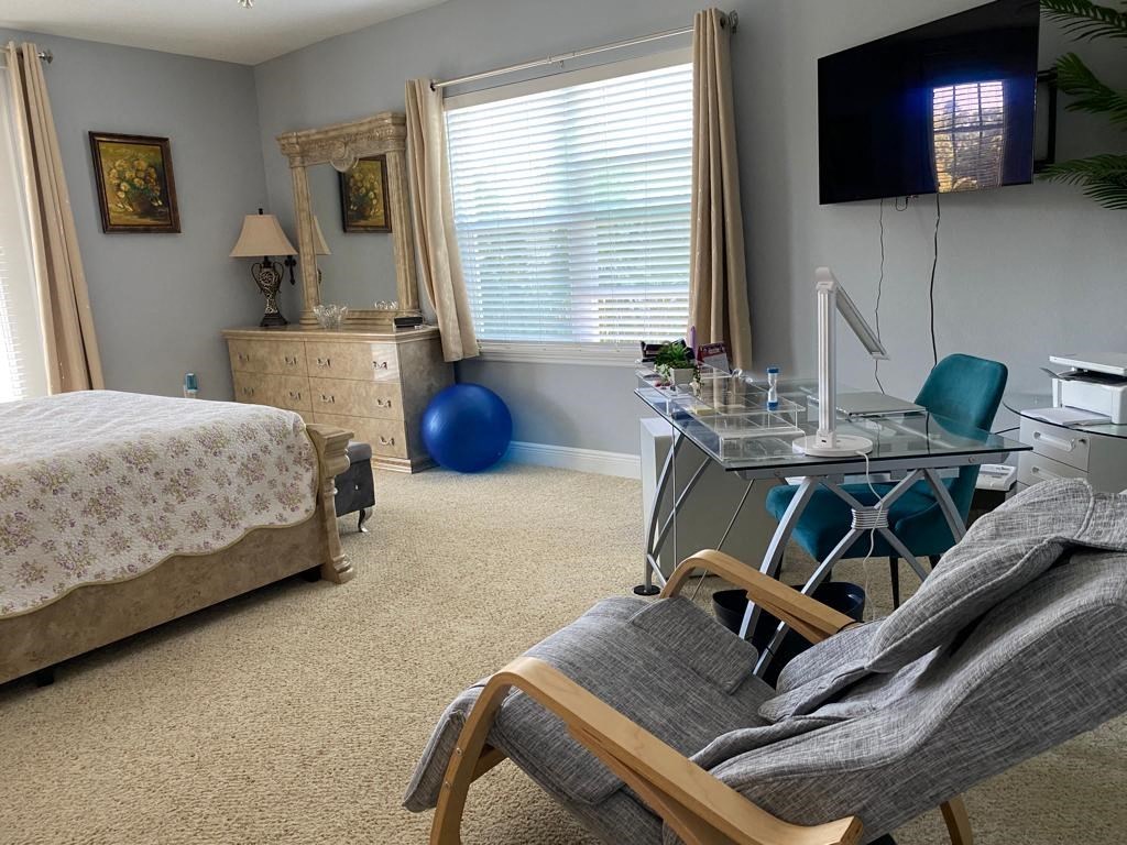 a bedroom with a bed and a desk with a chair