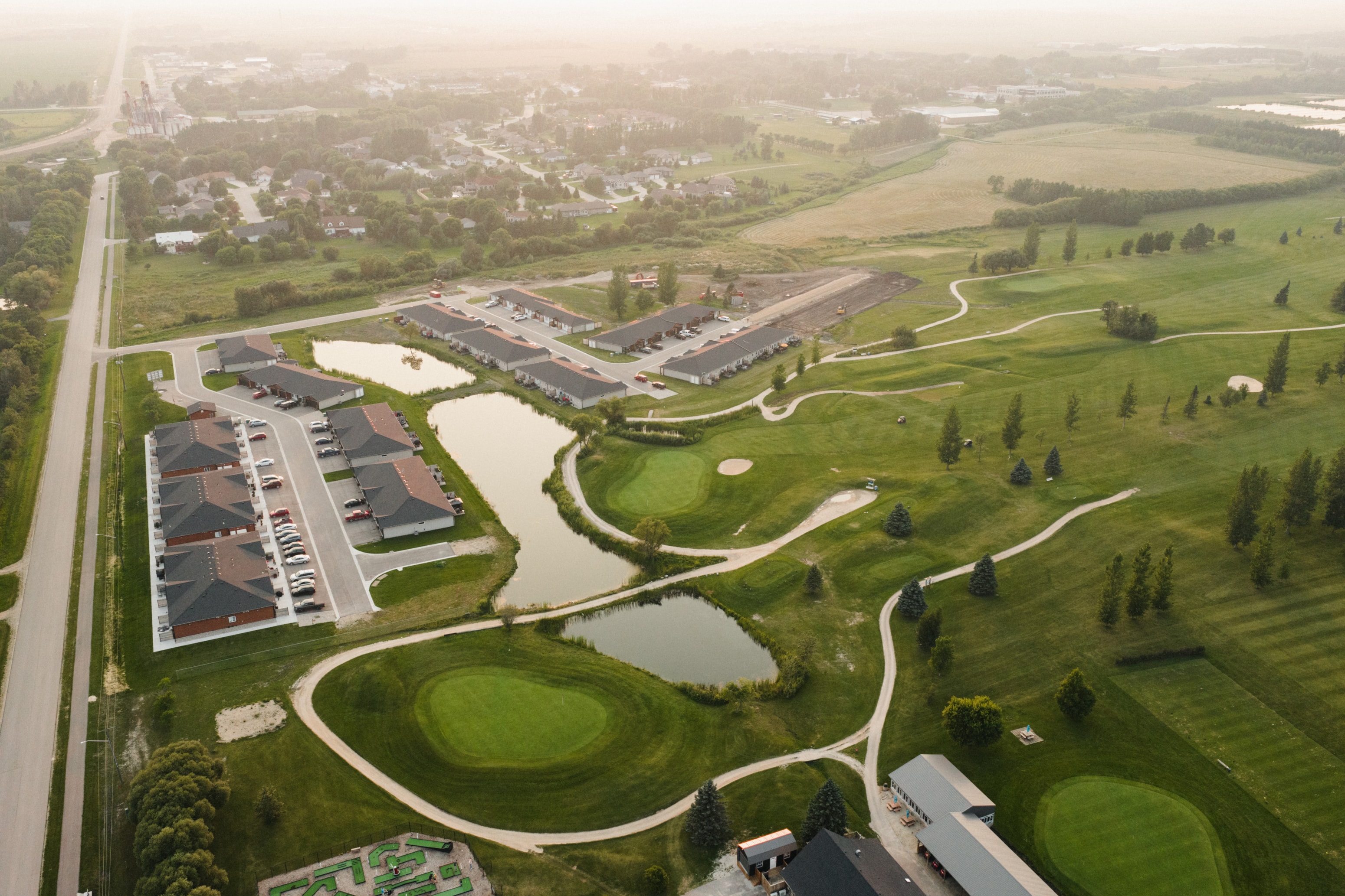 A golf course with a building in the background.