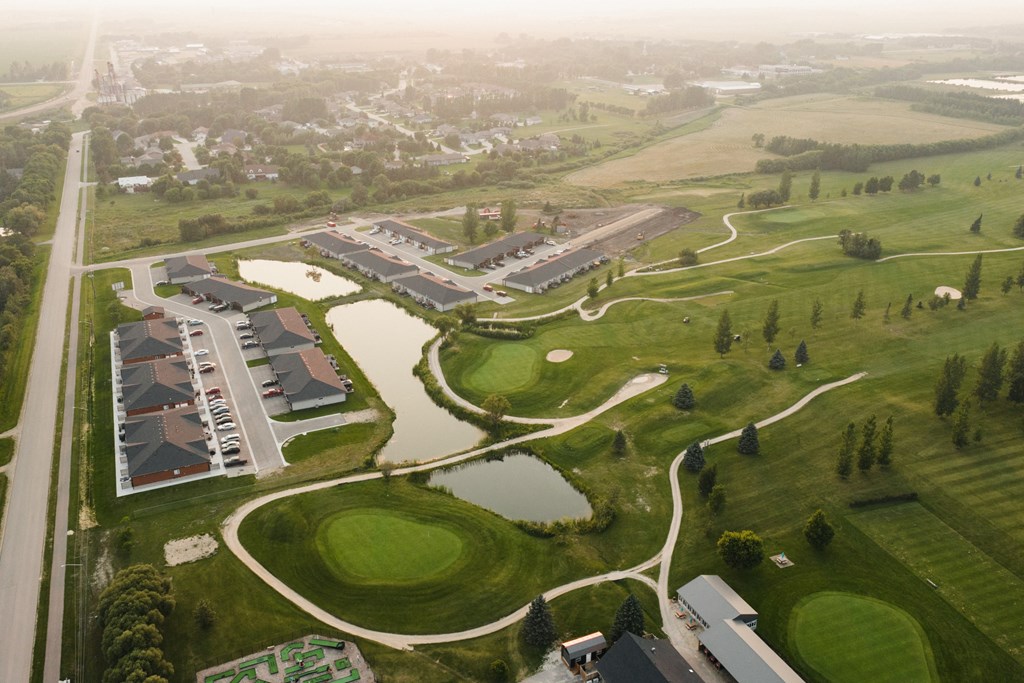 A golf course with a building in the background.