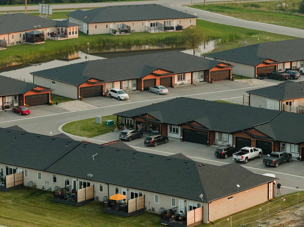 A bird's eye view of a residential area with houses and cars.