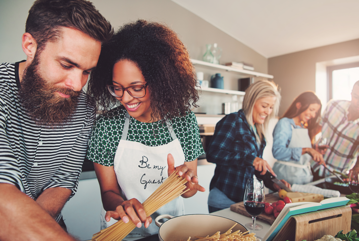 a group of people in a kitchen preparing food