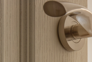 a door with a keychain with a house shaped door knob on it