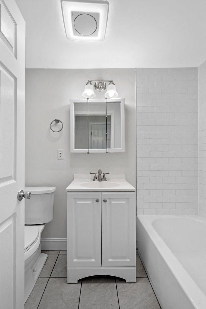 a white bathroom with a sink and a toilet