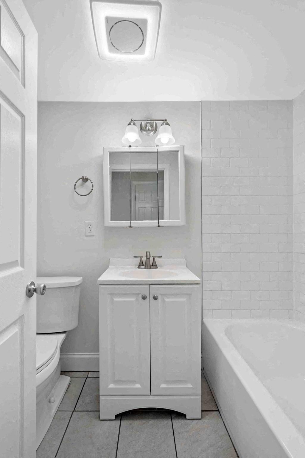 a white bathroom with a sink and a toilet