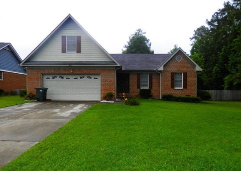 A house with a grey roof and a brick facade.