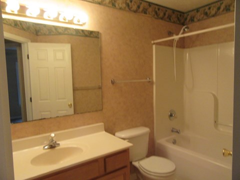 A bathroom with a sink, toilet, and bathtub.