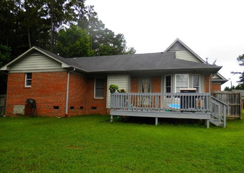 A house with a red brick exterior and a grey roof.