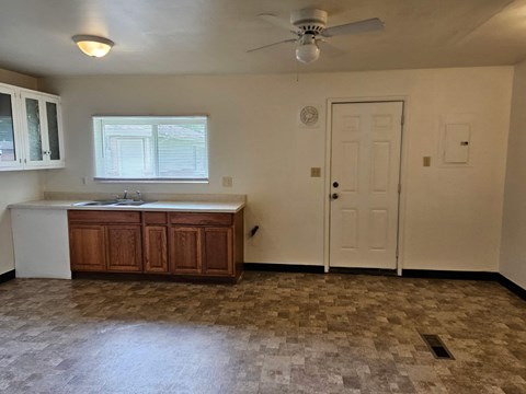 an empty kitchen with a sink and a door