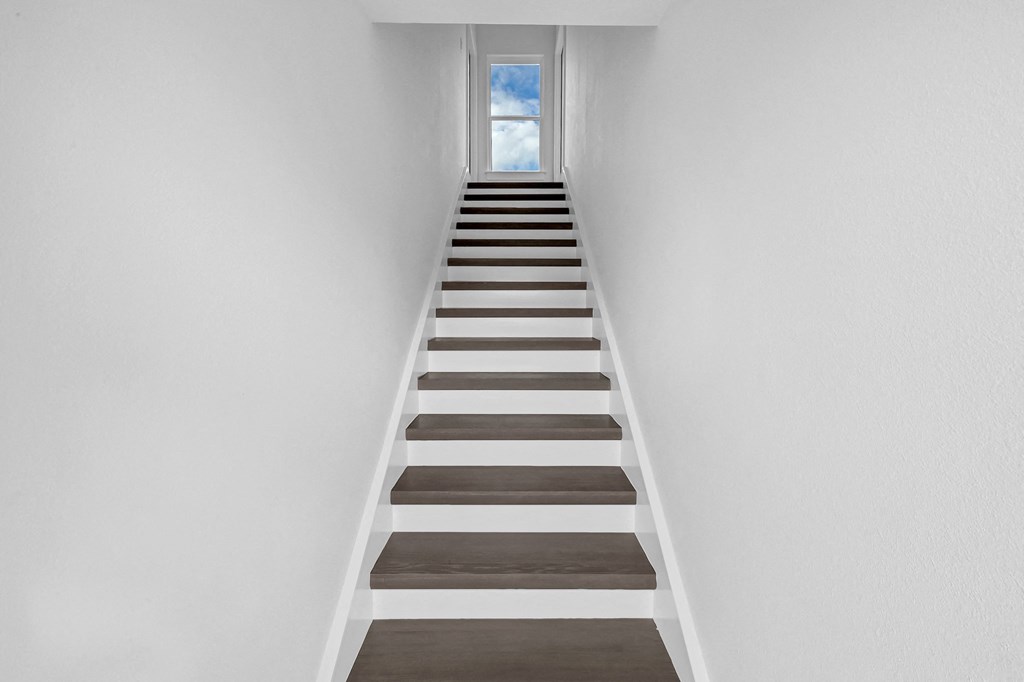 a set of stairs leading up to a window in a house