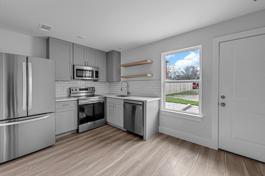a kitchen with stainless steel appliances and a window