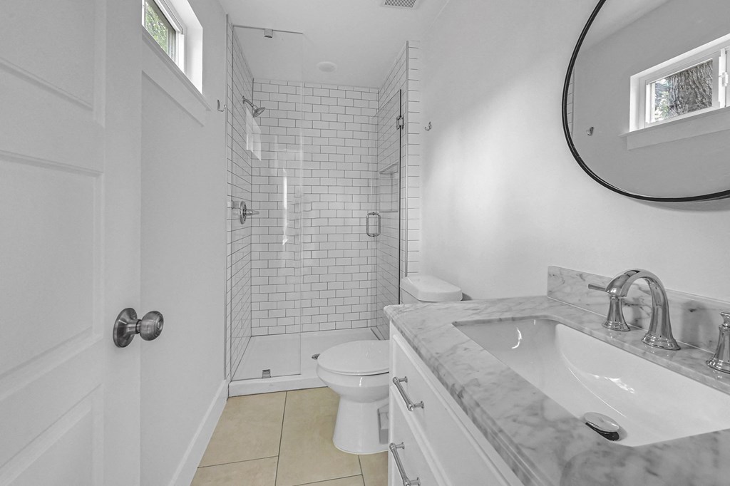 a bathroom with a sink and a toilet and a shower