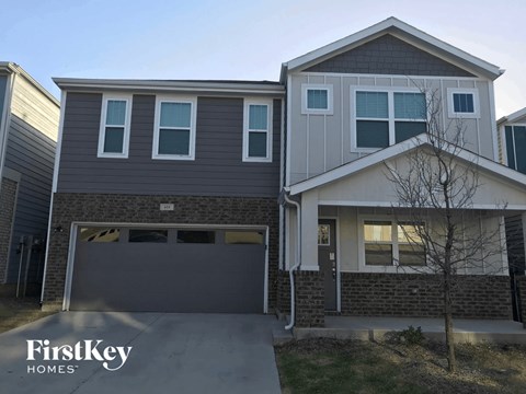 a house with a garage door in front of it