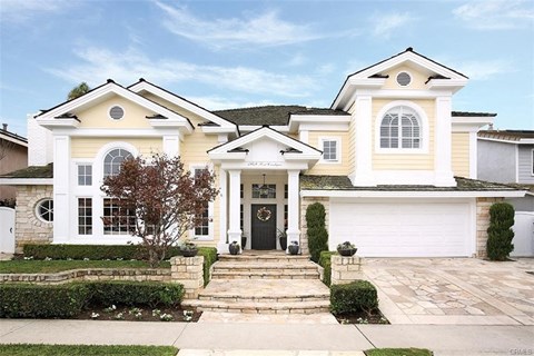 A large, two-story house with a white garage door and a black front door.