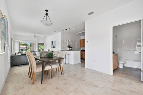 A dining room with a table and chairs.