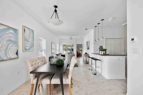 A dining room with a table and chairs is shown.
