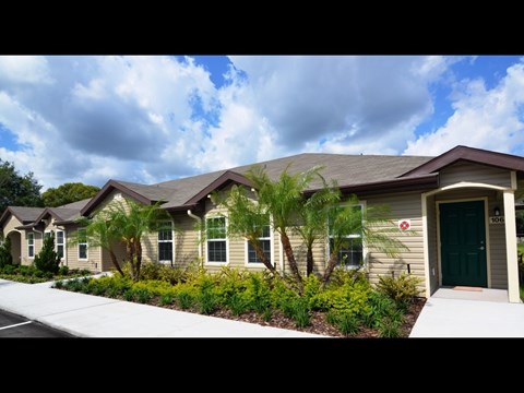 A row of houses with green doors and number 106.