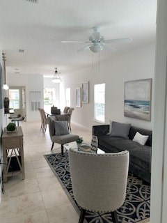 A living room with a grey couch and a rug.