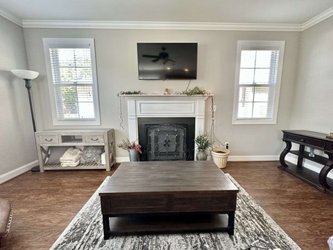 a living room with a fireplace and a table
