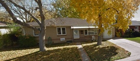 A house with a tree in front of it.