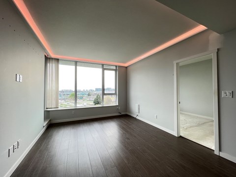 A room with a large window and a door.