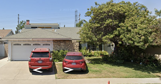 two cars parked in front of a house