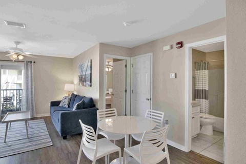 a living room with a table and chairs and a couch