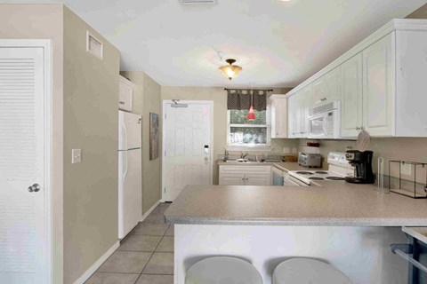 a kitchen with white cabinets and a counter top