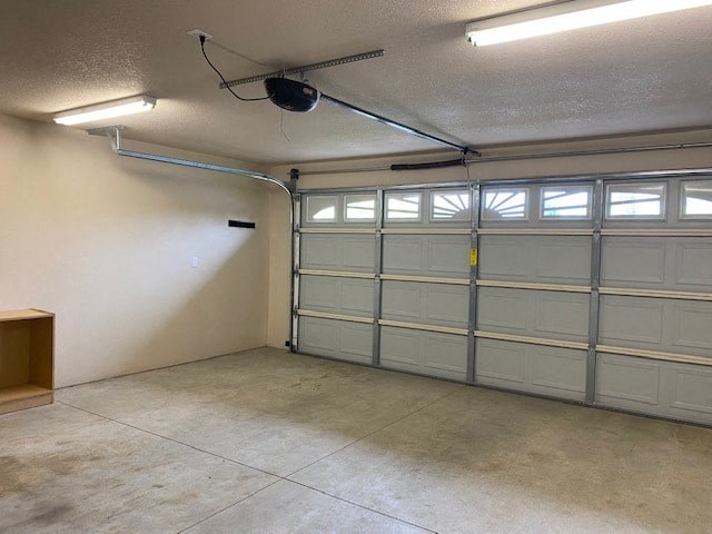 a garage with white doors and a ceiling fan