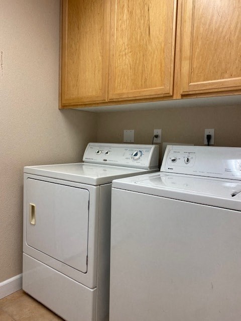 a washer and dryer in a room with wooden cabinets