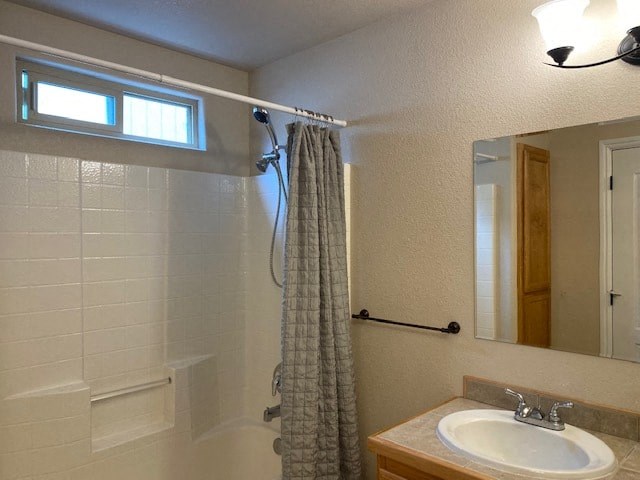 a bathroom with a shower and a sink and a mirror
