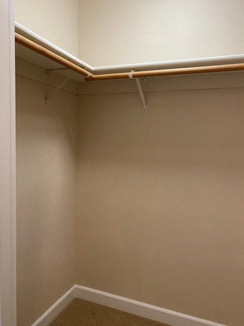 a empty closet with a pipe on the wall