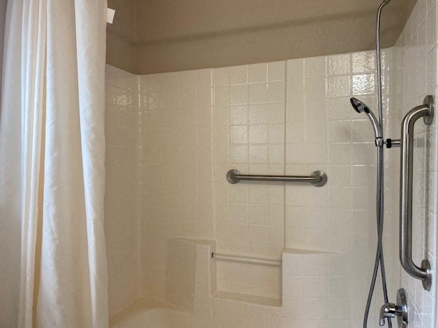 a bathroom with a shower and a white shower curtain
