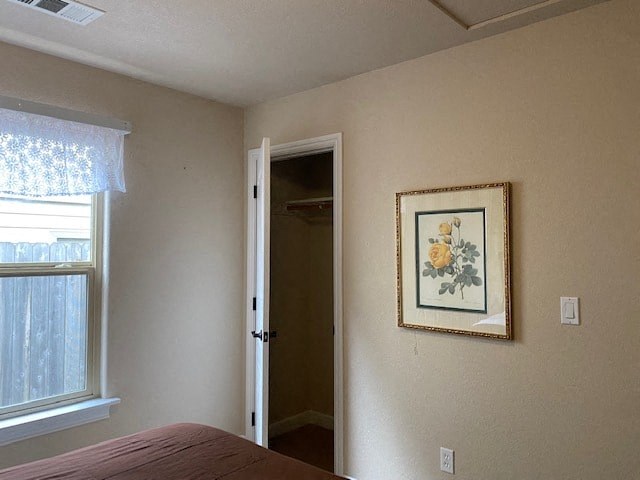 a bedroom with a painting on the wall and a door