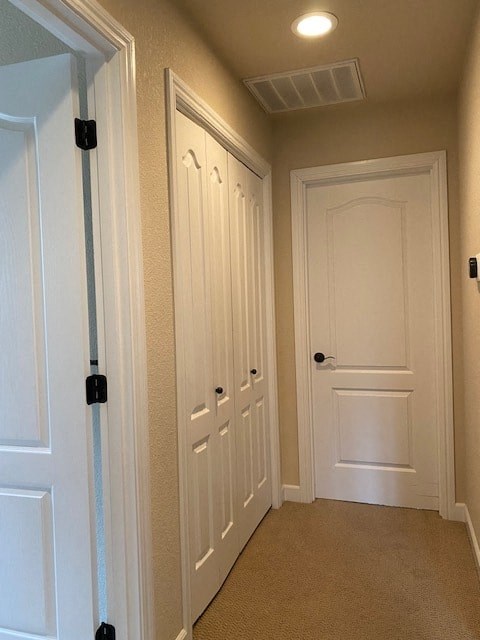 a hallway with two doors and a white door