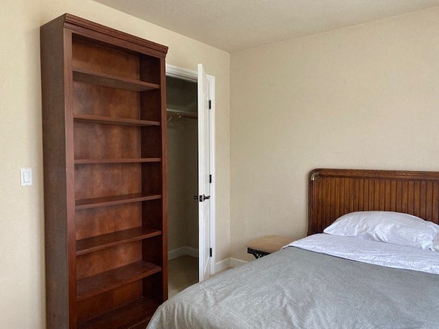 a bedroom with a bed and a book shelf