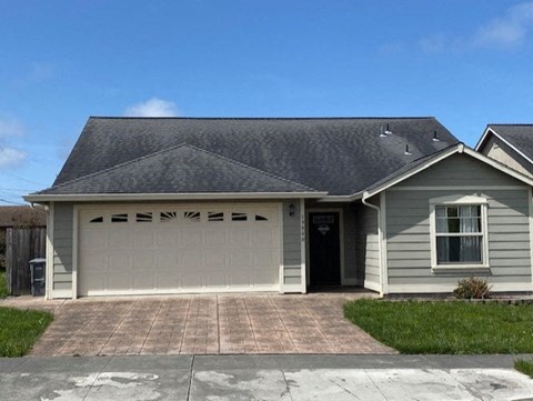 a white and gray house with a garage door
